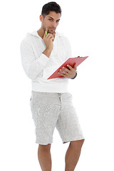 Image showing Thoughtful man holding a red clipboard