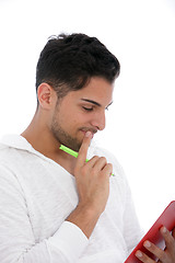 Image showing Thoughtful man reading from a clipboard