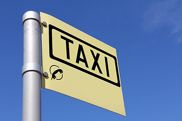 Image showing Yellow Taxi Sign against Blue Sky