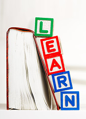 Image showing Learn alphabet Block besides book