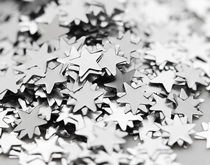 Image showing Scattered glittering stars confetti close up