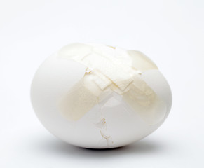 Image showing Cracked white egg with plastic plaster