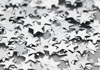 Image showing Scattered glittering stars confetti in silver color