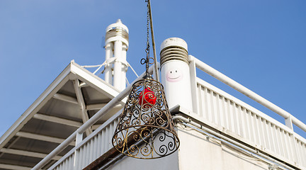 Image showing building hung brass squirm lampshade red light 