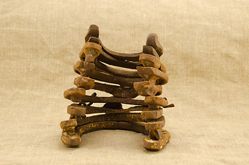 Image showing stack pile retro rusty horseshoes linen background 