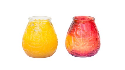 Image showing Red and yellow candle in glass