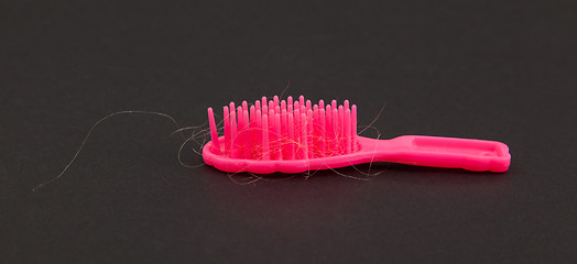 Image showing Pink toy brush with hair