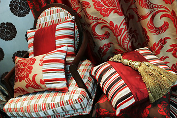 Image showing Luxurious red chair with satin pillows