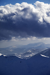 Image showing Snow mountains and storm clouds