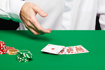 Image showing player's hand throws a playing card