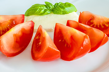 Image showing Italian appetizer tomatoes with mozarella and basil