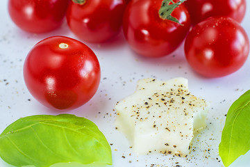 Image showing Italian apppetizer tomatoes with mozarella and basil