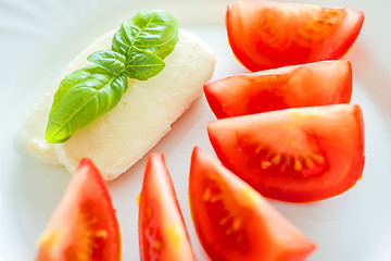 Image showing Italian appetizer tomatoes with mozarella and basil