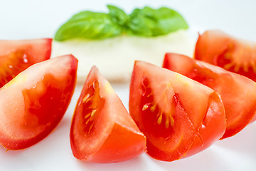 Image showing Italian appetizer tomatoes with mozarella and basil