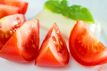 Image showing Italian appetizer tomatoes with mozarella and basil