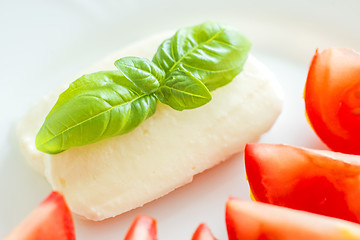 Image showing Italian appetizer tomatoes with mozarella and basil
