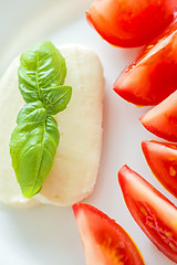 Image showing Italian appetizer tomatoes with mozarella and basil