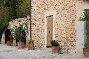 Image showing Old stone building with potted plants