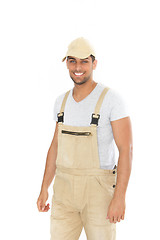 Image showing Smiling handsome man in dungarees and cap