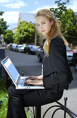 Image showing happy businesswoman with laptop computer b