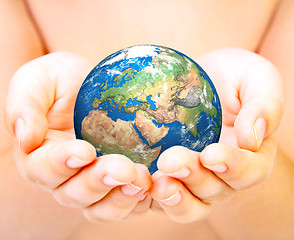 Image showing Hand of the person holds globe.