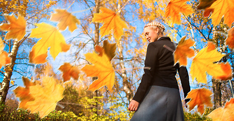 Image showing Woman and autumn leaves in the park.