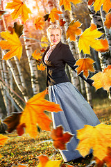 Image showing Woman and autumn leaves in the park.