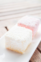 Image showing Pink and white lamington cakes on wood table