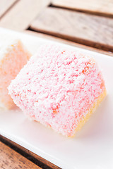 Image showing Pink lamington cakes up close on wood table