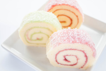 Image showing Colorful jam roll cakes  on white background 