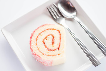 Image showing Strawberry jam roll cake with spoon and fork