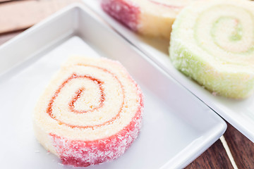 Image showing Colorful jam rolls served on white dish