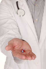 Image showing Caucasian Doctor With Medication in Hand Reaching Out