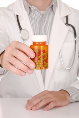 Image showing Doctor With Medication in Prescription Bottles