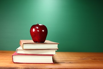 Image showing Apple Plus Stack of Books on A Desk for Back to School