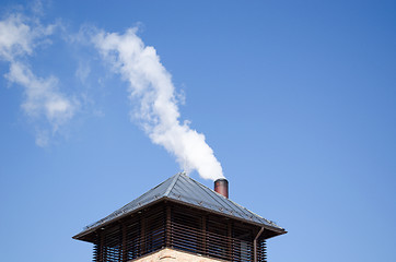 Image showing modern tin roof smoke rise chimney pipe blue sky 