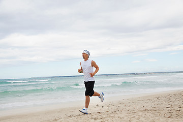 Image showing man is jogging on the beach summertime sport fitness