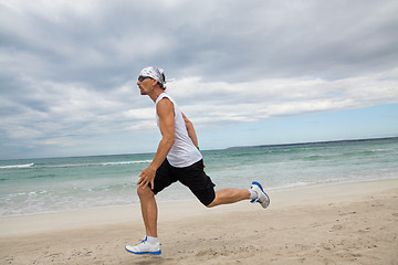 Image showing man is jogging on the beach summertime sport fitness