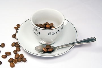 Image showing Tight closeup of espresso cup and saucer with beans