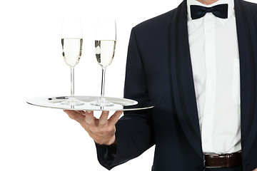 Image showing adult male waiter serving two glass of champagne isolated