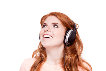 Image showing attractive happy woman with headphones listen to music isolated