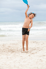 Image showing happy little child kid boy  playing beachball on beach in summer 