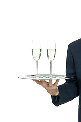 Image showing adult male waiter serving two glass of champagne isolated