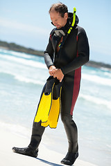 Image showing male diver with diving suit snorkel mask fins on the beach