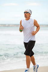 Image showing man is jogging on the beach summertime sport fitness