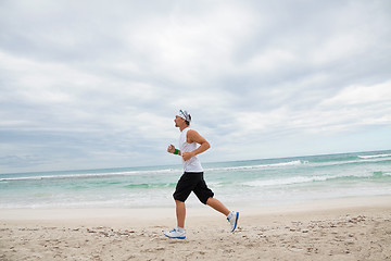 Image showing man is jogging on the beach summertime sport fitness