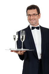 Image showing adult male waiter serving two glass of champagne isolated