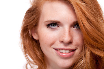 Image showing beautiful young smiling woman with red hair and freckles isolated