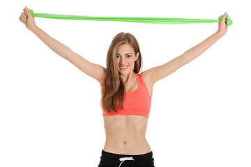 Image showing athletic young woman doing workout with physio tape latex tape