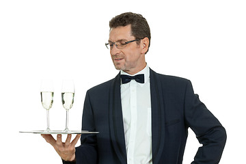 Image showing adult male waiter serving two glass of champagne isolated